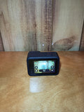 Black action camera with front touchscreen display on tabletop