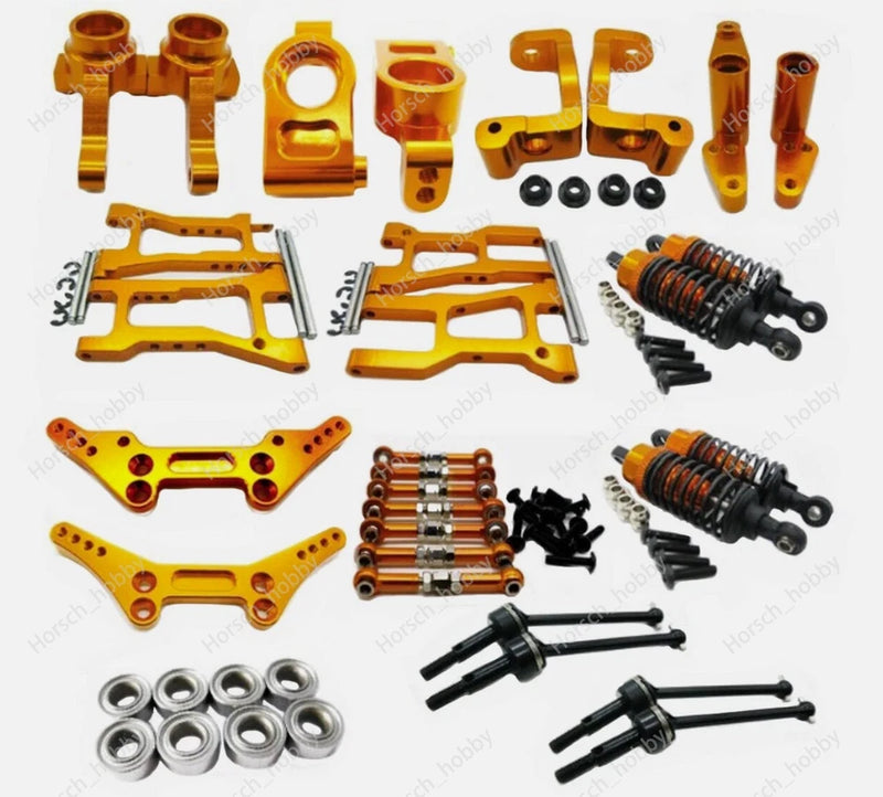 Orange aluminum RC car upgrade kit parts with suspension shocks and screws