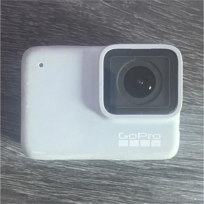 White GoPro action camera with lens and rear housing