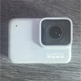 White GoPro action camera with lens and rear housing
