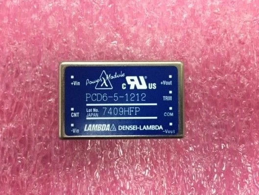 DC-DC converter module in metal case with blue label and input/output markings.
