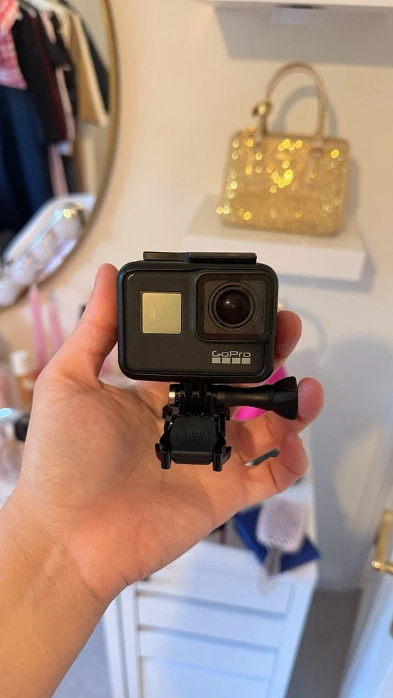 GoPro HERO7 Black 4K action camera with front lens and small screen, handheld