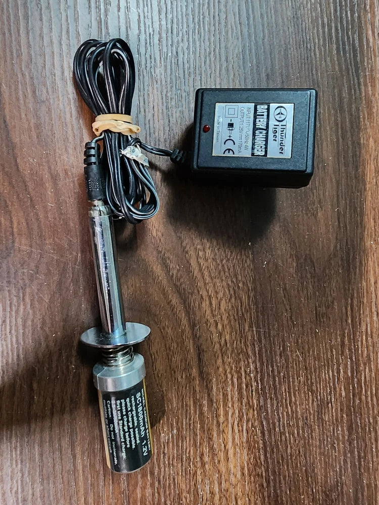Glow starter with battery charger and connected cables