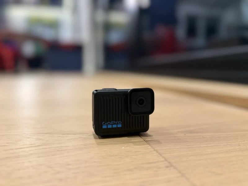 GoPro HERO action camera in black, showing side lens and charging port.