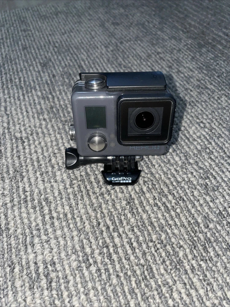 GoPro waterproof action camera in gray housing with display, lens, and helmet mount