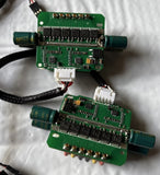 Two brushless RC ESC PCB boards, green circuits with connectors and capacitors