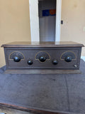 Antique 5-tube battery radio with dark wood cabinet and three large front tuning knobs