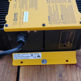 Industrial battery charger with yellow top panel, black body, and connected power cable