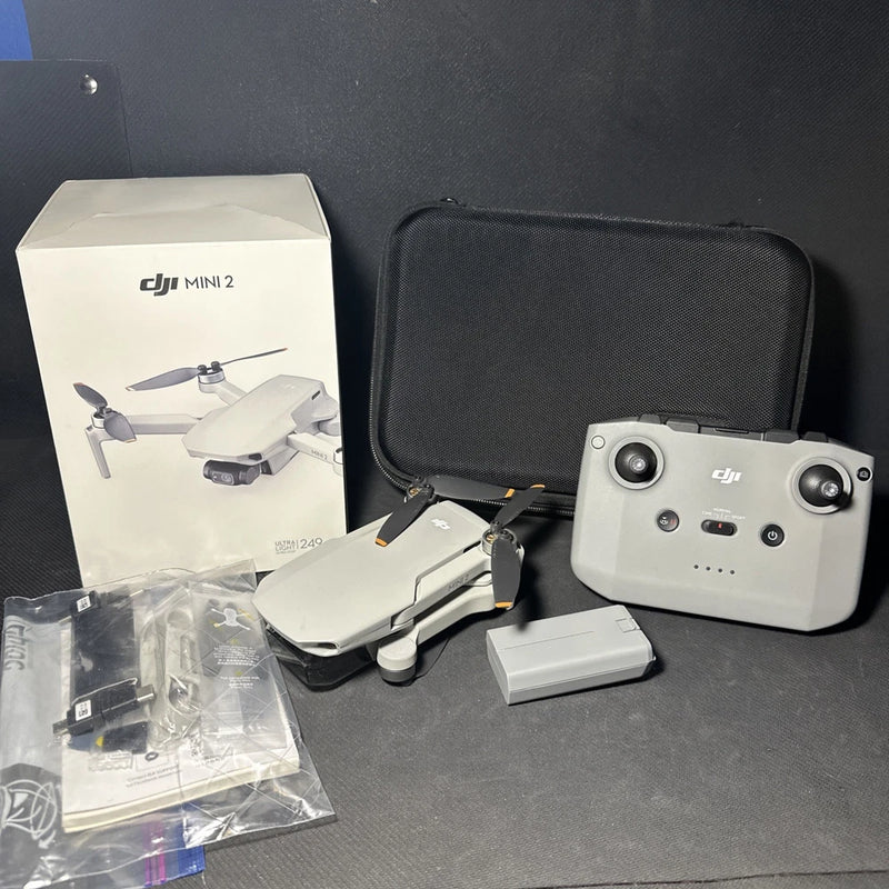 DJI Mini 2 foldable drone kit with light gray controller and carrying case