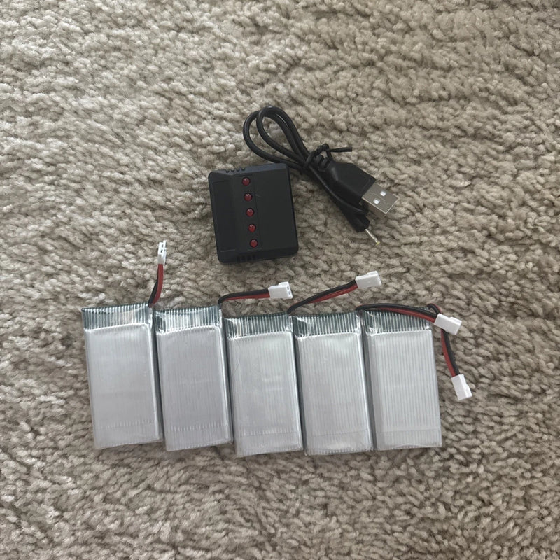 Drone battery pack set with multiple LiPo cells and balance wiring, plus USB charger