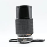 Nikon Ai-s 50-135mm zoom lens with textured grip, focus ring, and front cap