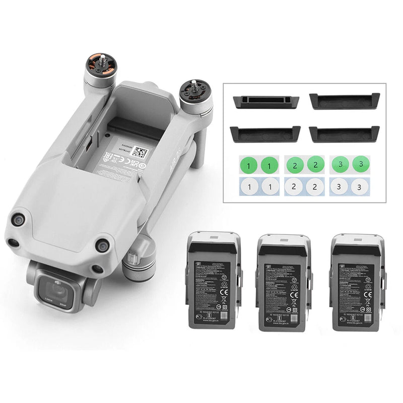 Drone charging port dust plug cover set with four dark inserts and matching gray covers