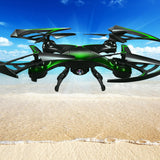 Black RC quadcopter drone with green accents, four propellers, front camera