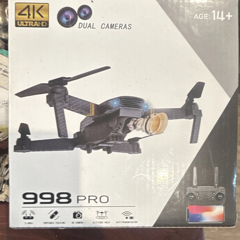 Foldable micro quadcopter drone with dual cameras on retail box
