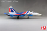 Blue, red, and white Su-30SM jet model aircraft with landing gear down.