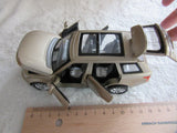 Beige toy Range Rover model with open driver door, detailed front and headlights