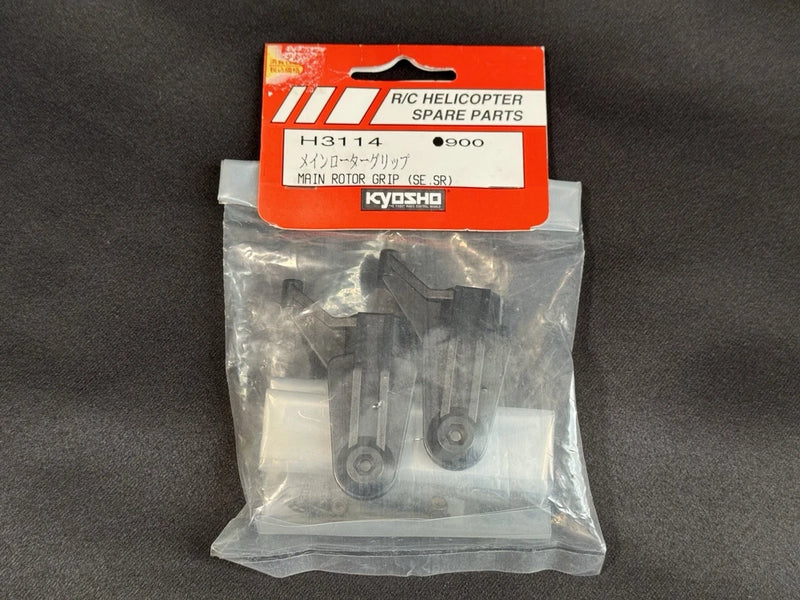 RC helicopter main rotor grip spare part in clear sealed bag with orange label