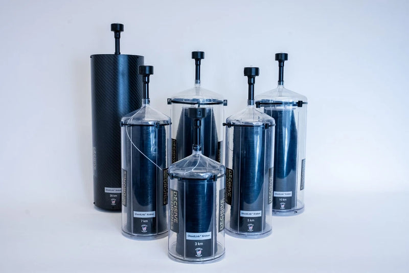Set of dark and clear cylindrical fiber canisters with vent caps