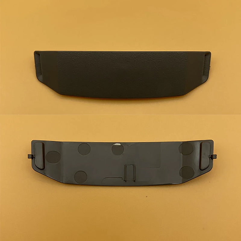 Protective drone cover hood in dark gray/black with curved shape and side straps
