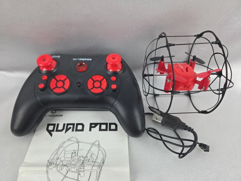 Black nano quadcopter drone with red controller and wireframe prop cage