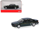 Green and black sedan model car with detailed wheels, in clear display box