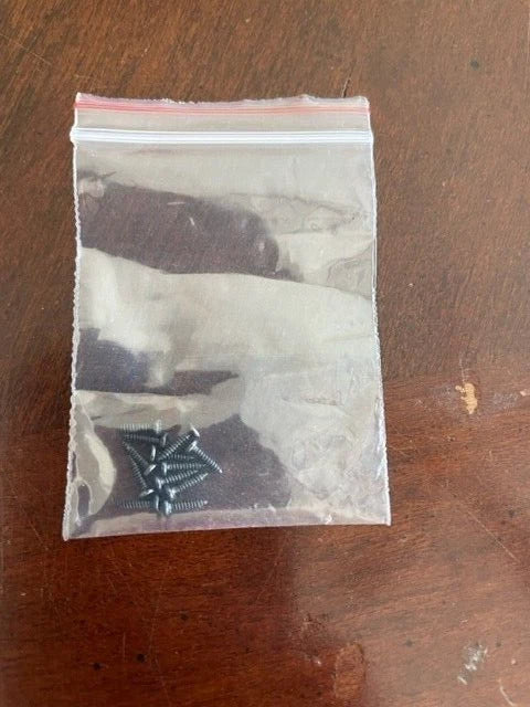 Package of small black RC drone replacement screws in clear plastic bag