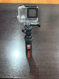 Black and red mini tripod/selfie stick with action camera mount and clamp