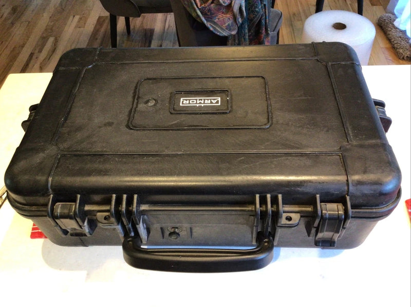 Hard drone hard case with molded exterior, latch clips, and top label