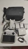 DJI Mini 3 Pro kit with drone, controller, batteries, and carrying bag