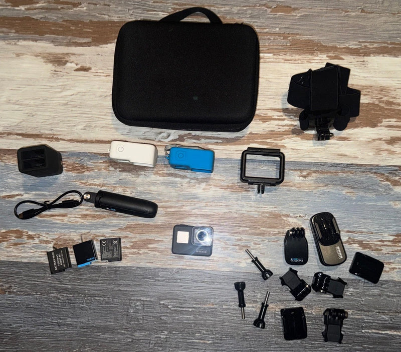 Action camera accessory bundle with protective housing, black case, mounts, and screens