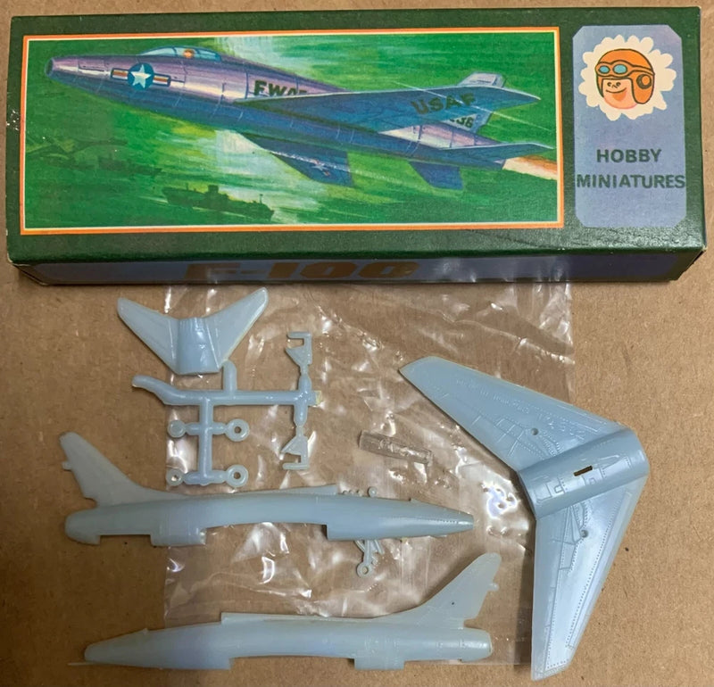 Blue F-100 Super Sabre plastic airplane model kit parts on sprue, fuselage