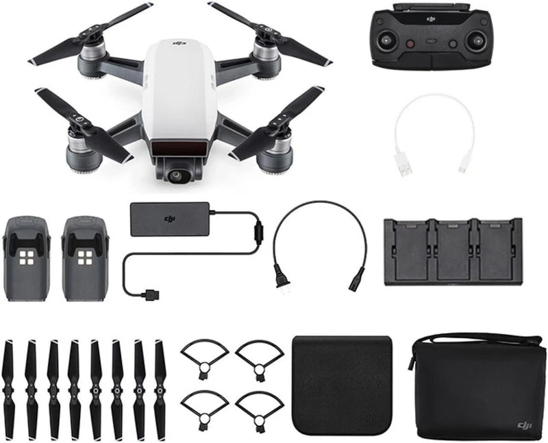 White quadcopter drone with controller, spare propellers, battery and carry case