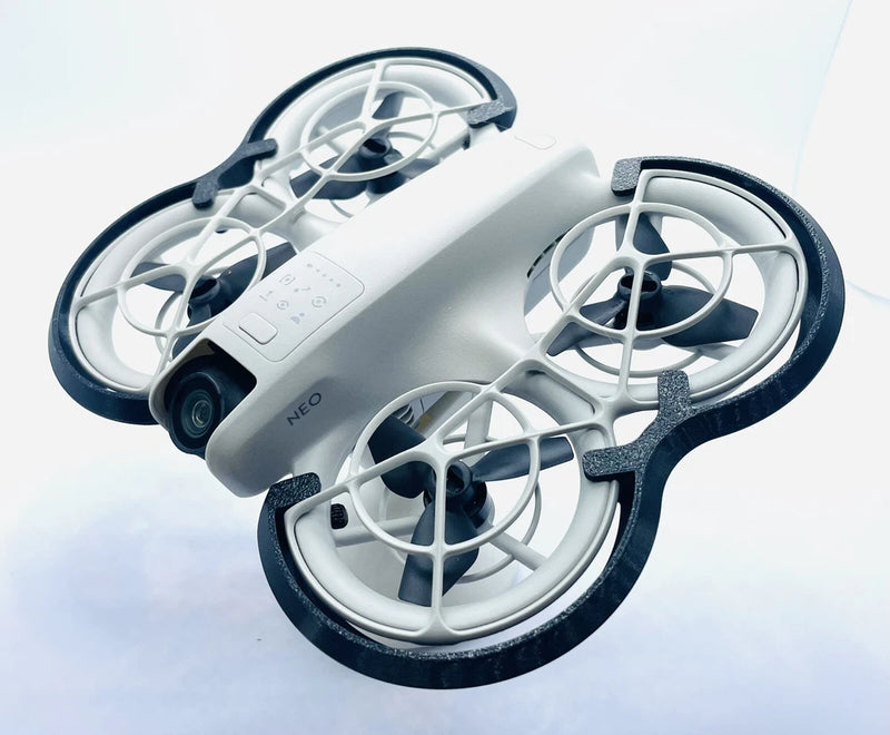 Black prop guard bumper with curved duct guards around three drone propellers