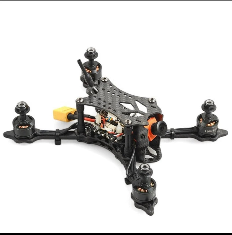 140mm micro brushless FPV racing drone, black quad frame with four motors and orange accents