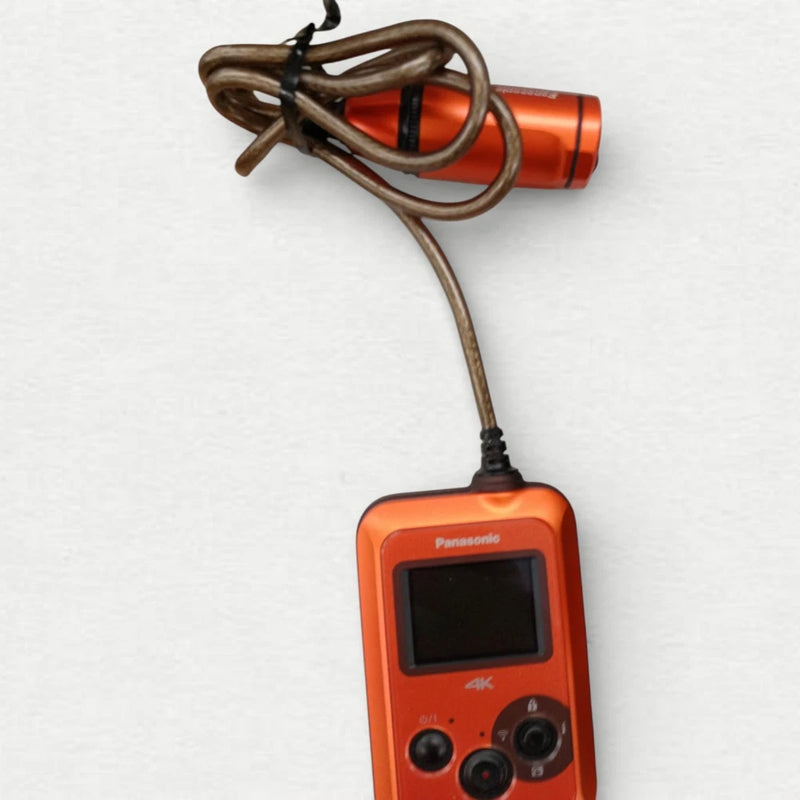 Panasonic orange wearable 4K POV camcorder with front screen, controls, and attached cable