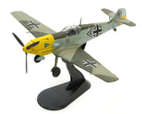Camouflaged WWII fighter plane model with yellow nose and Luftwaffe markings on stand