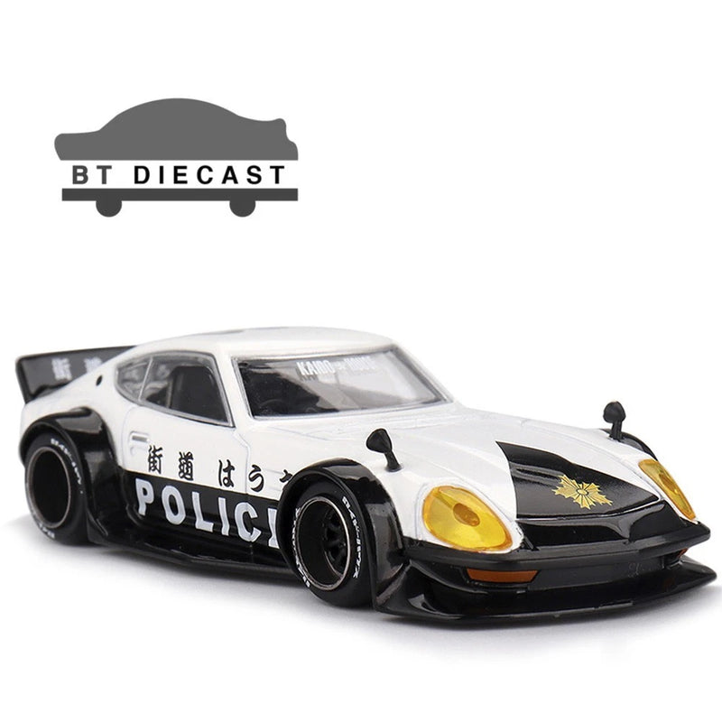 White and black police car diecast model with front headlights and hood graphic, 1:64 scale