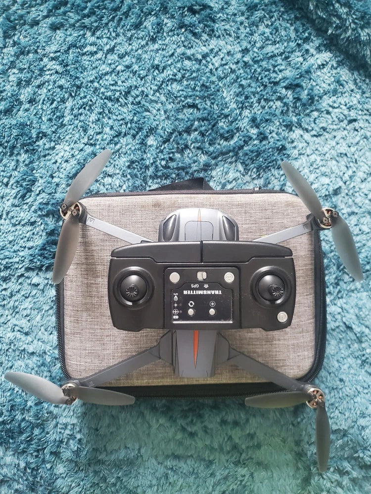 Foldable quadcopter drone with front camera and four propellers, grey body