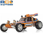 Orange and blue RC model car with white wheels and exposed suspension springs
