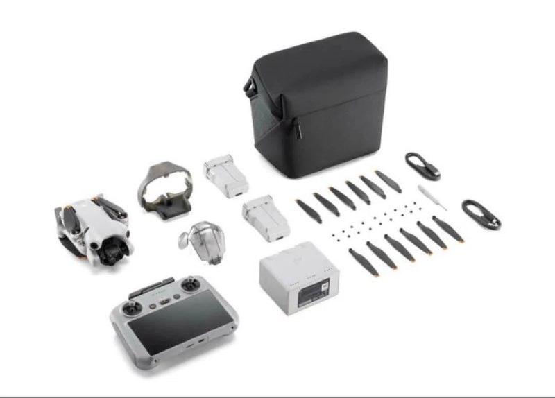 Dji Mini 4 Pro drone kit with remote, batteries, propellers, cables, and carrying case
