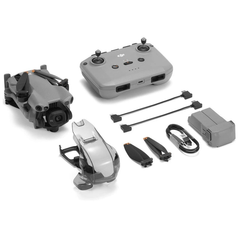 Foldable grey drone with remote controller and charging accessories