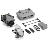 Foldable grey drone with remote controller and charging accessories