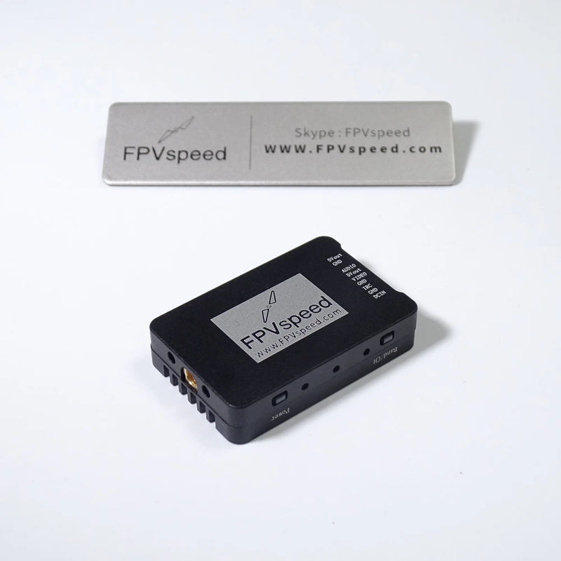 Black FPV video transmitter module with multiple I/O ports and label
