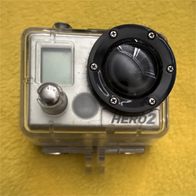 Waterproof action camera in clear case with black lens and HERO2 logo