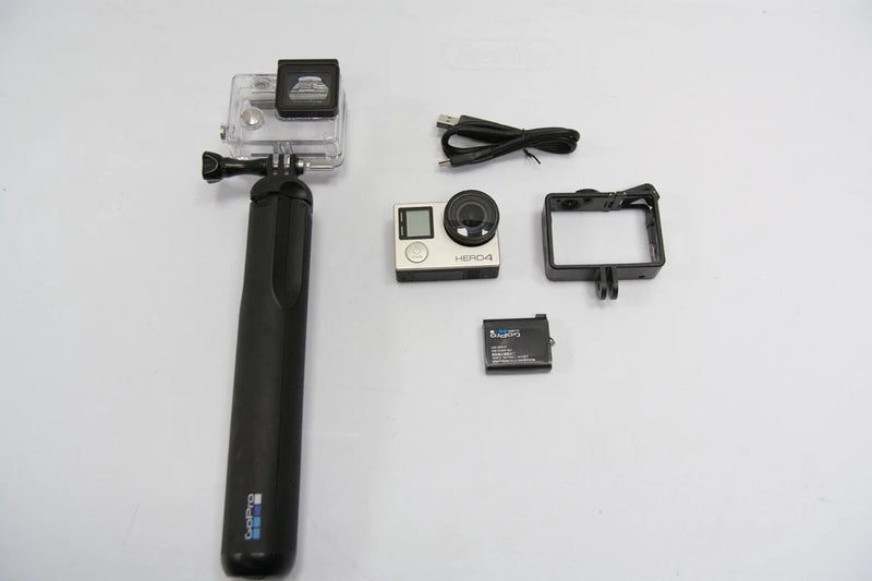 GoPro HERO 4 action camera kit with black grip, mounts, and battery accessories