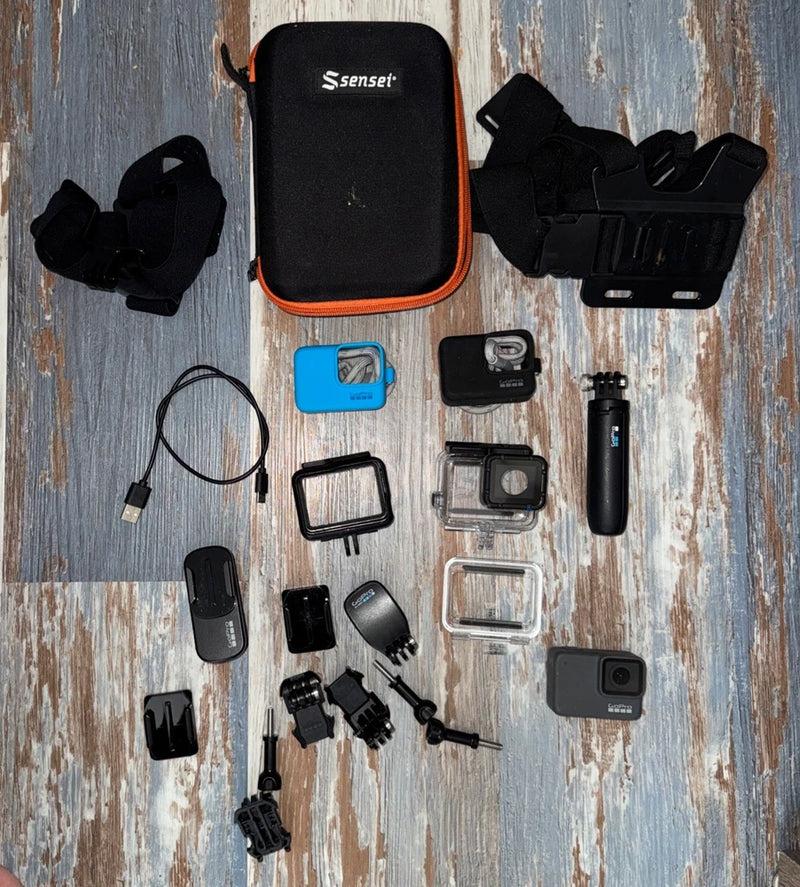 Waterproof action camera bundle with protective housing, mounts, and slim wrist strap