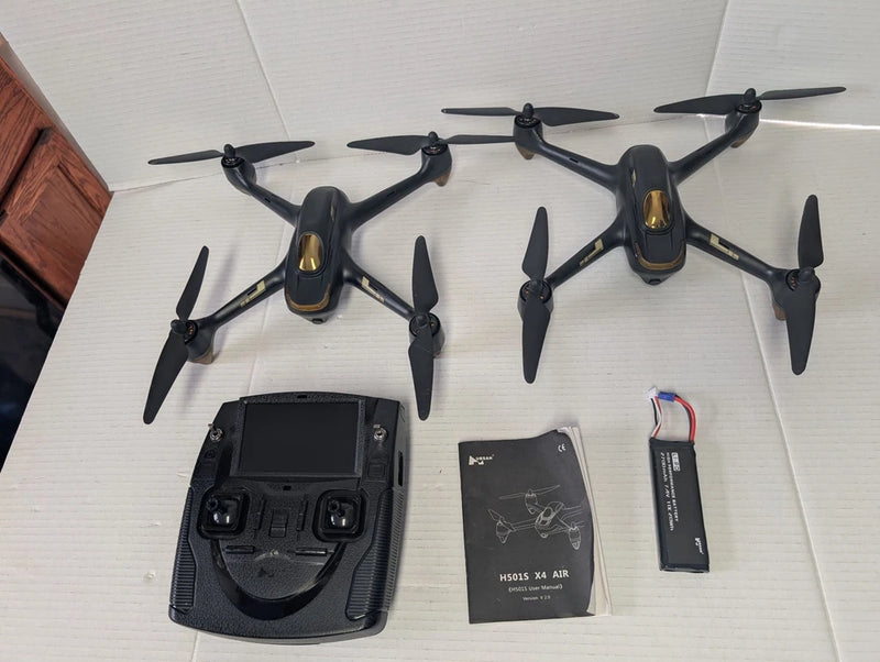 Hubsan H501S X4 FPV drone set with transmitter, battery, and manual