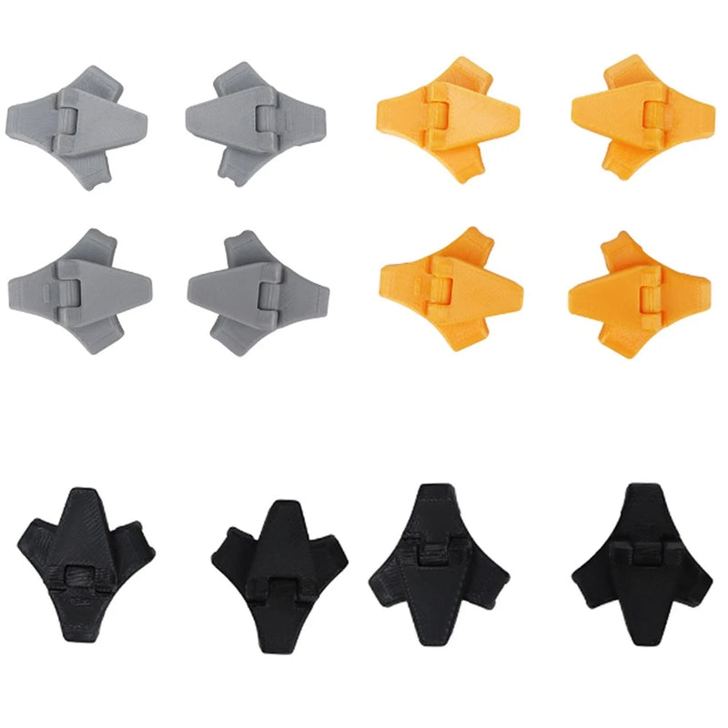 Drone landing gear protector kit, four cross-shaped pads in gray, orange, and black