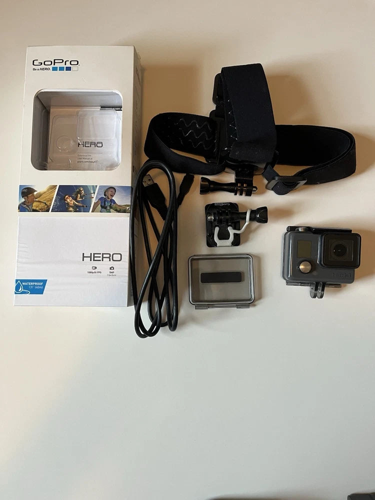 GoPro HERO action camera kit with waterproof housing, mounts, battery cover, and LCD screen