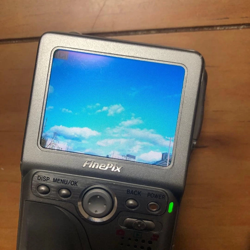 Fujifilm FinePix compact digital camera with blue LCD screen and control buttons